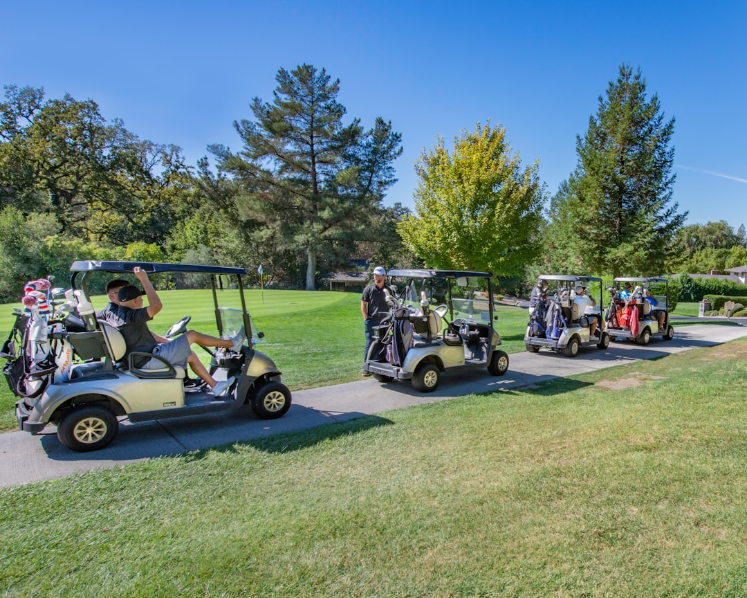four golf carts on the move to the next hole