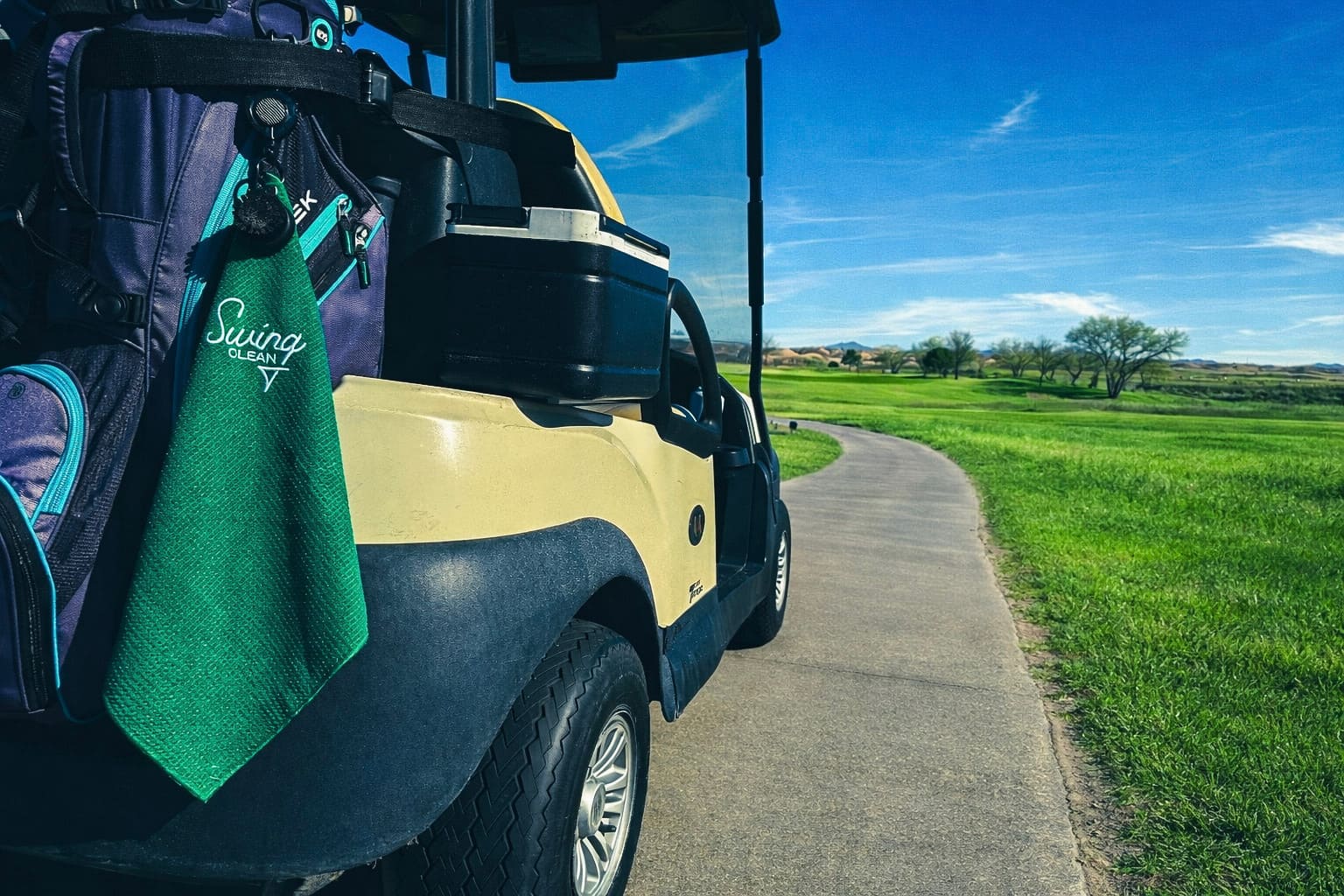 Golf cart on green golf course path