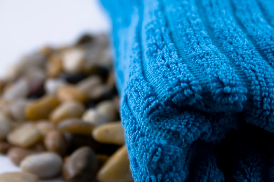 Closeup of blue towel next to pebbles