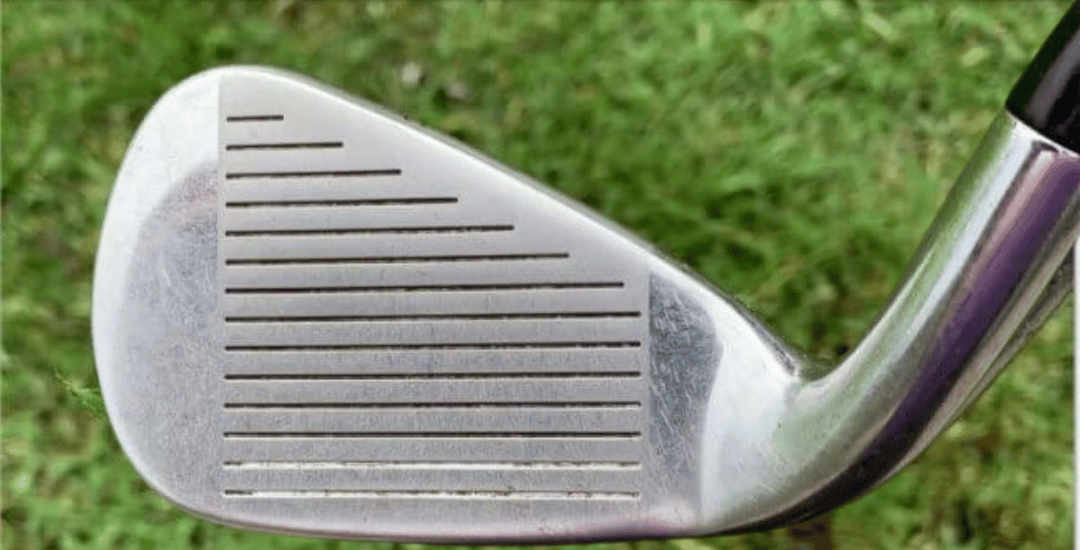 Clean golf iron face with clear grooves after brushing