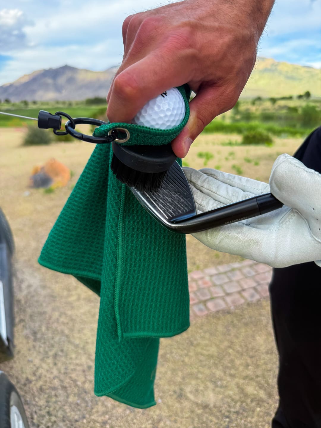 Green Duo Pro brush scrubbing debris out of iron grooves mid-round