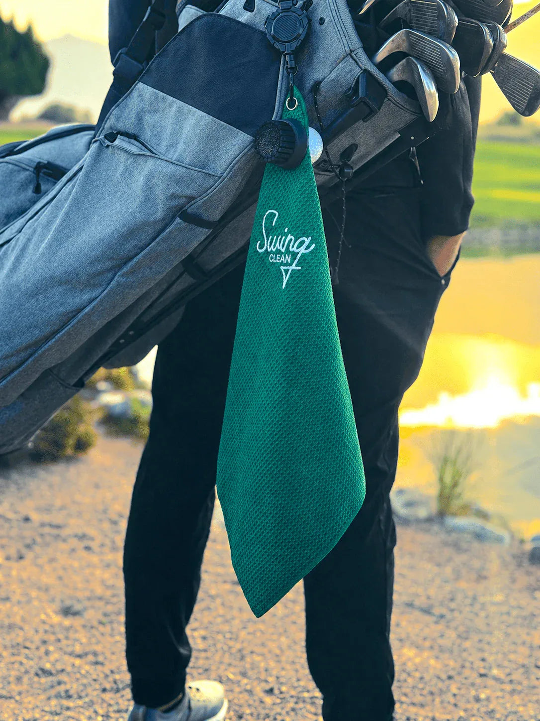 Swing Clean Duo Pro golf towel and brush clipped to a golf bag
