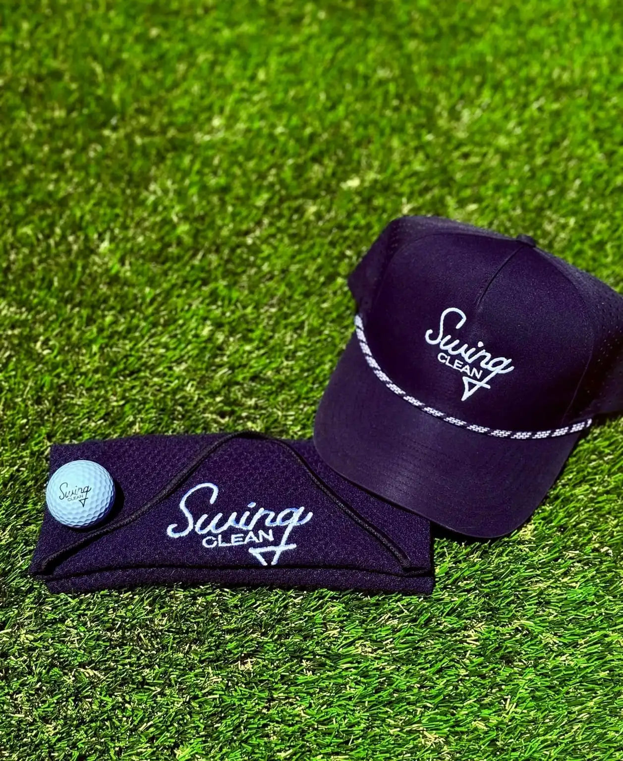 Swing Clean black waffle towel with golf hat and ball